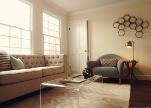 Mid-century modern living room with tufted fabric loveseat and accent chair