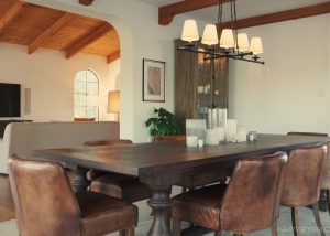 Classic, modern dining room in Spanish home with leather chairs and storage