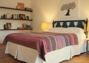 Spanish, eclectic bedroom with floating wood wall shelves