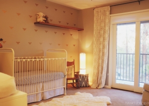 Neutral eclectic nursery - metal crib, rocking chair, and dragonfly wallpaper